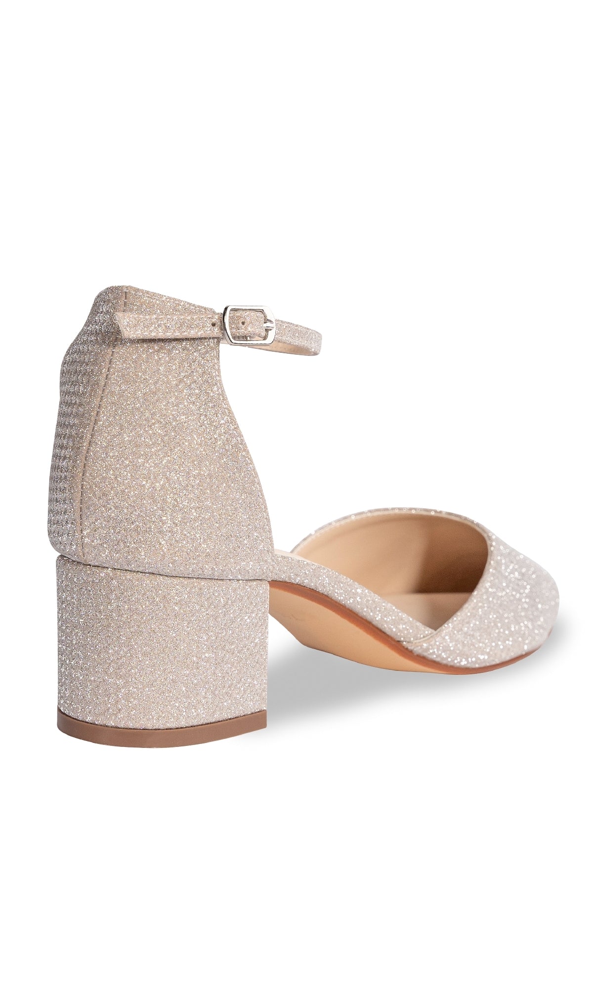 The Tegan Champagne Shimmer Prom Shoe by Touch Ups 4664 features a glittery finish, closed back, ankle strap with buckle, block heel, and pointed toe—shown here from the rear view.